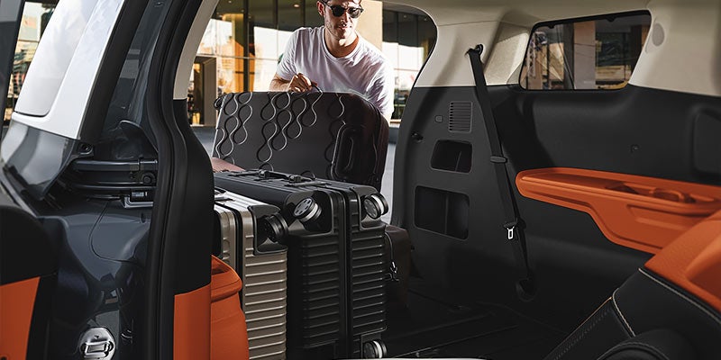 Kia Carnival rear cargo area with deep floor well and third-row seats folded flat
