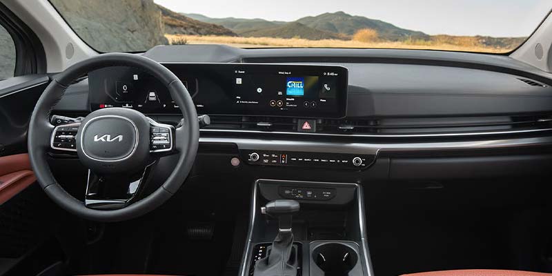Kia Carnival interior showcasing driver-assist displays and safety technology