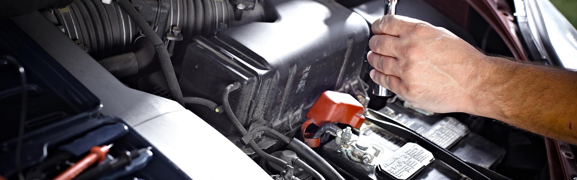 Kia-certified technician performing battery service at Cable Dahmer Kia of Lawrence